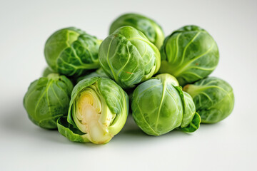 Fototapeta premium A close-up image showcasing a fresh green Brussels sprout. The intricate leaf pattern is clearly visible against the light grey background. This image is perfect for themes around healthy, organic, an