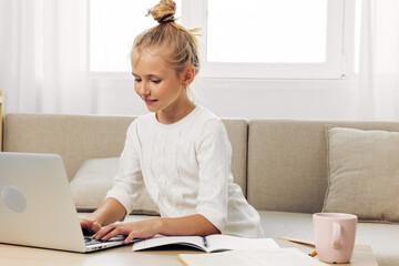 Laptop child education homework distance couch school schoolgirl online learning