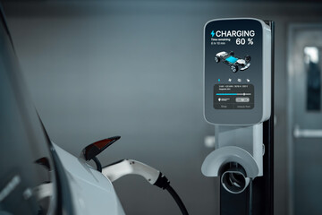 EV electric car recharge at shopping center parking lot charging in downtown city showing urban...