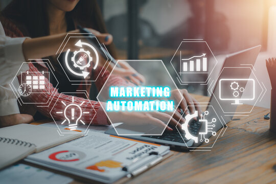 Marketing automation concept, Business team working on laptop computer with marketing automation icon on virtual screen.