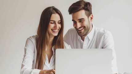 Two young happy smiling successful businesspeople working with laptop on office background....