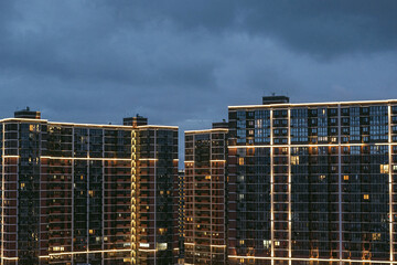 Modern night city, View of a high-rise building in the light of the lanterns of the night metropolis