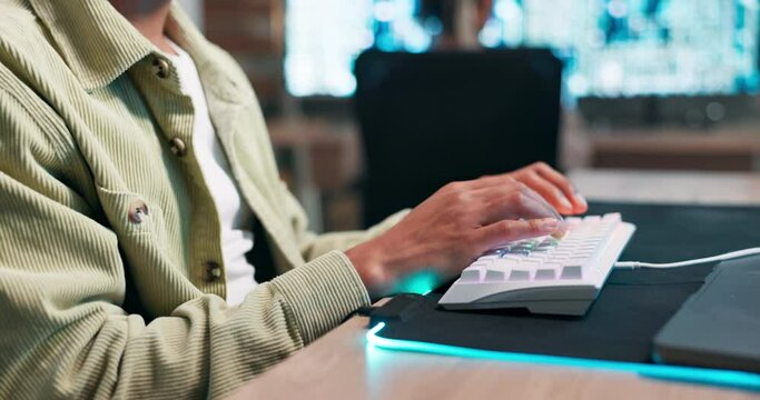 Hands, keyboard or typing with productivity in office on neon mousepad or connection for computer programming. Person, working and busy on information technology for software and networking at night