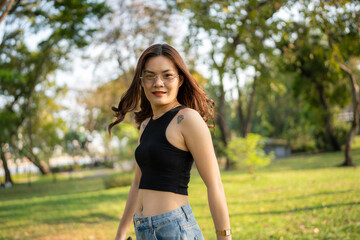 Portrait of asian woman relax in city park sunset light sky - 735544721