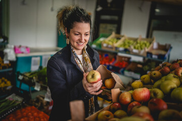 Woman grocery shopping at the local store with paper bag