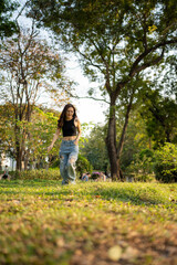 Naklejka premium Portrait of asian woman relax in city park sunset light sky