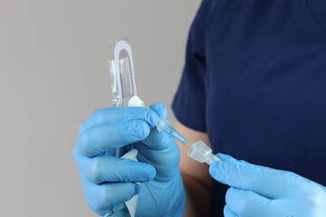 Health care professional wearing gloves manipulating the peripheral catheter pack 