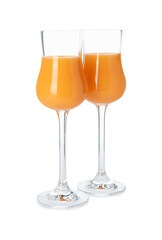 Glasses with tasty tangerine liqueur isolated on white