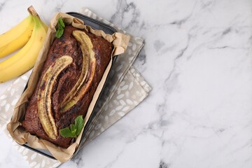 Delicious banana bread and fresh fruits on white marble table, top view. Space for text