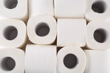 Many soft toilet paper rolls as background, above view