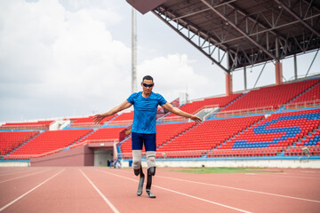 Asian para-athlete with prosthetic blades warms up body in the stadium. 