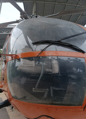 Fototapeta na wymiar Zoom view of an orange helicopter in the hangar