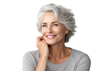 Happy middle aged woman, senior older 50 year lady looking at camera touching her face isolated on white close up face portrait