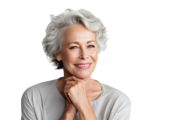 Happy middle aged woman, senior older 50 year lady looking at camera touching her face isolated on white close up face portrait