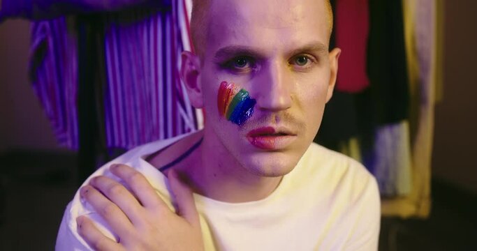 Direct Gaze: LGBT Individual with Pride Flag on Cheek
