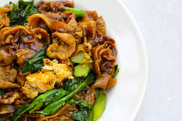 Stir-fried rice noodles with soy sauce and pork