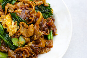 Stir-fried rice noodles with soy sauce and pork