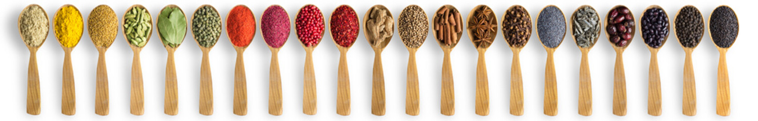 spices and herbs in wooden spoons on white table. Indian seasonings for cooking delicious food.