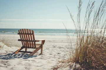 Fototapeta premium Empty beach chair on the sand by the sea.