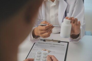 Healthcare service and pharmacy worker with customer at store counter for medication explanation. Pharmaceutical advice and opinion of pharmacist helping girl with medicine information.