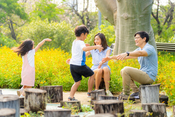 Happy Asian family enjoy and fun outdoor lifestyle on summer holiday vacation. Parents and little...