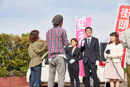 選挙活動をするスーツを着た男性