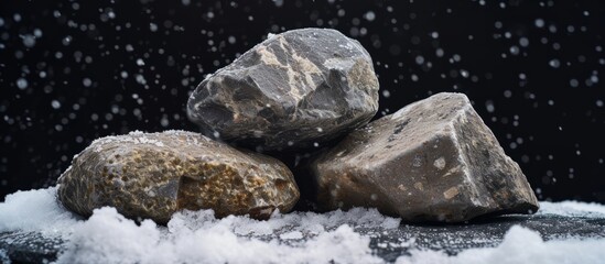 Tranquil winter landscape with three rocks resting on snow covered ground