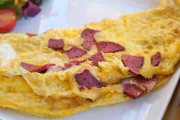 Plain Egg Omelette with sausage on table 