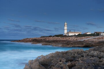 Fototapeta na wymiar long exposure view of the Cap de ses Salines Lighthouse on Mallorca just before sunrise