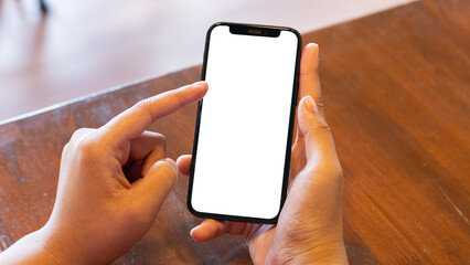 Close-up male office worker or employee using his smartphone at his office desk. smartphone white screen mockup