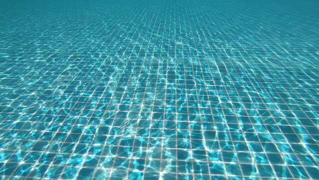 diving into the water on blue swimming pool, beautiful pool texture background