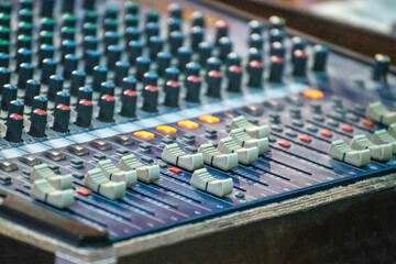 Sound engineer using mixing console to produce a sound track.