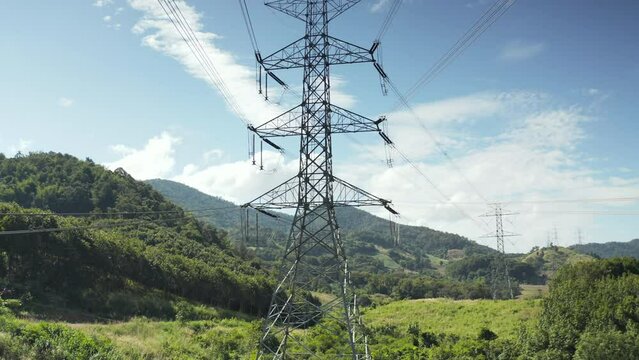 Transmission tower in aerial view. May called electricity pylon, steel utility pole consist of steel structure framing to support carry high-voltage cable or overhead power line for electrical grid.