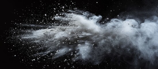 Ethereal white powder explosion on dramatic black background for creative, artistic, and impactful...