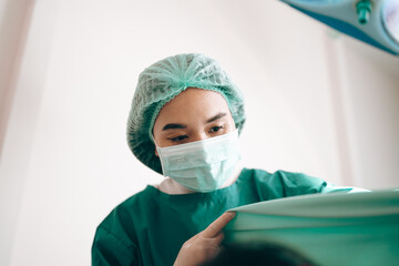 concentrated professional surgeons team during operation process in surgery by stand up through...
