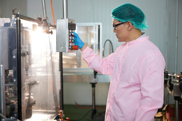 male worker working on machine in the beverage factory