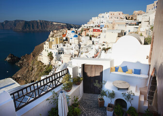 Fototapeta premium Santorini Serenity: Cliffside View of Blue Domes and Aegean Sea