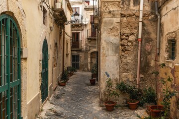 shabby neighborhood street with run-down buildings in the Old Town of Siracusa