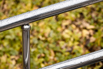 metal handrail with raindrops, shot with shallow depth of field