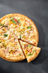 Hawaiian pizza with chicken, pineapple, and corn, a sweet and savory combination on a perfectly baked crust