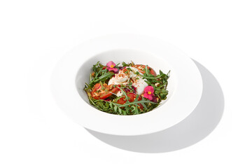 Italian salad with burrata, tomatoes, and arugula, elegantly arranged and garnished with edible flowers