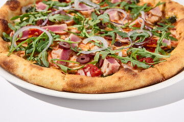 Gourmet tuna and olive pizza in nicoise style on a white background