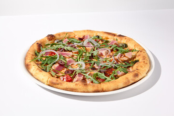 Gourmet tuna and olive pizza in nicoise style on a white background