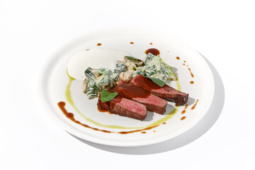 Beef steak with creamed spinach and mushrooms on elegant white dish, ideal for fine dining and gourmet cuisine