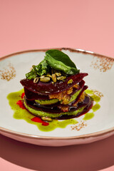 Beetroot mille-feuille with pesto sauce creatively plated, ideal for fresh and healthy menu options