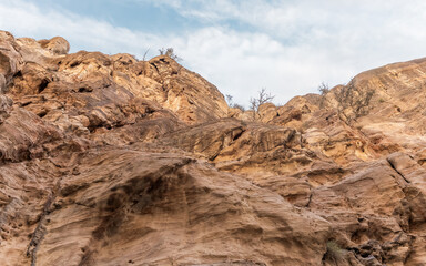 The indescribable beauty of high mountains on sides of gorge of tourist route of gorge Wadi Al Ghuwayr or An Nakhil and wadi Al Dathneh near Amman in Jordan