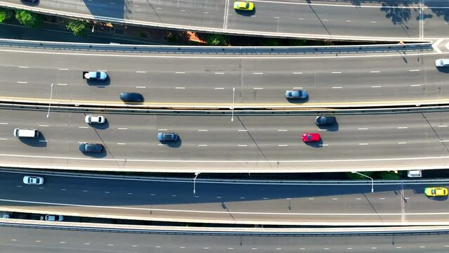 4K UHD : Aerial view, Drone surveys a vast highway expanse, emblematic of modern transport efficiency. Urban Mobility and Autonomous Vehicles concept.
