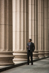 Indian Lawyer or business man outside a colonial building.