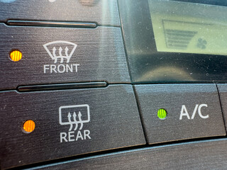 Front and rear defrost button closeup