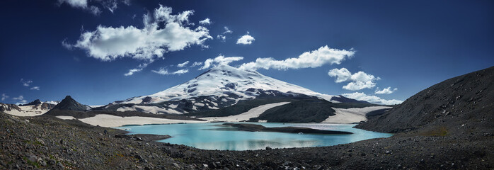 Caucasus Elbrus majestic mountain peak, blue sky lake, snow covered glacier, rocky landscape,...